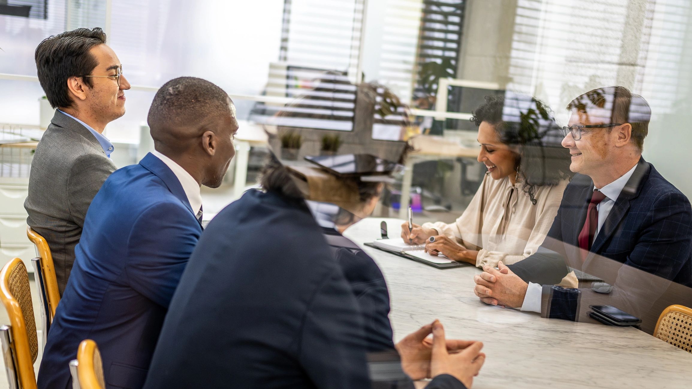 Investors and advisors reviewing a commercial real estate deal at a conference table