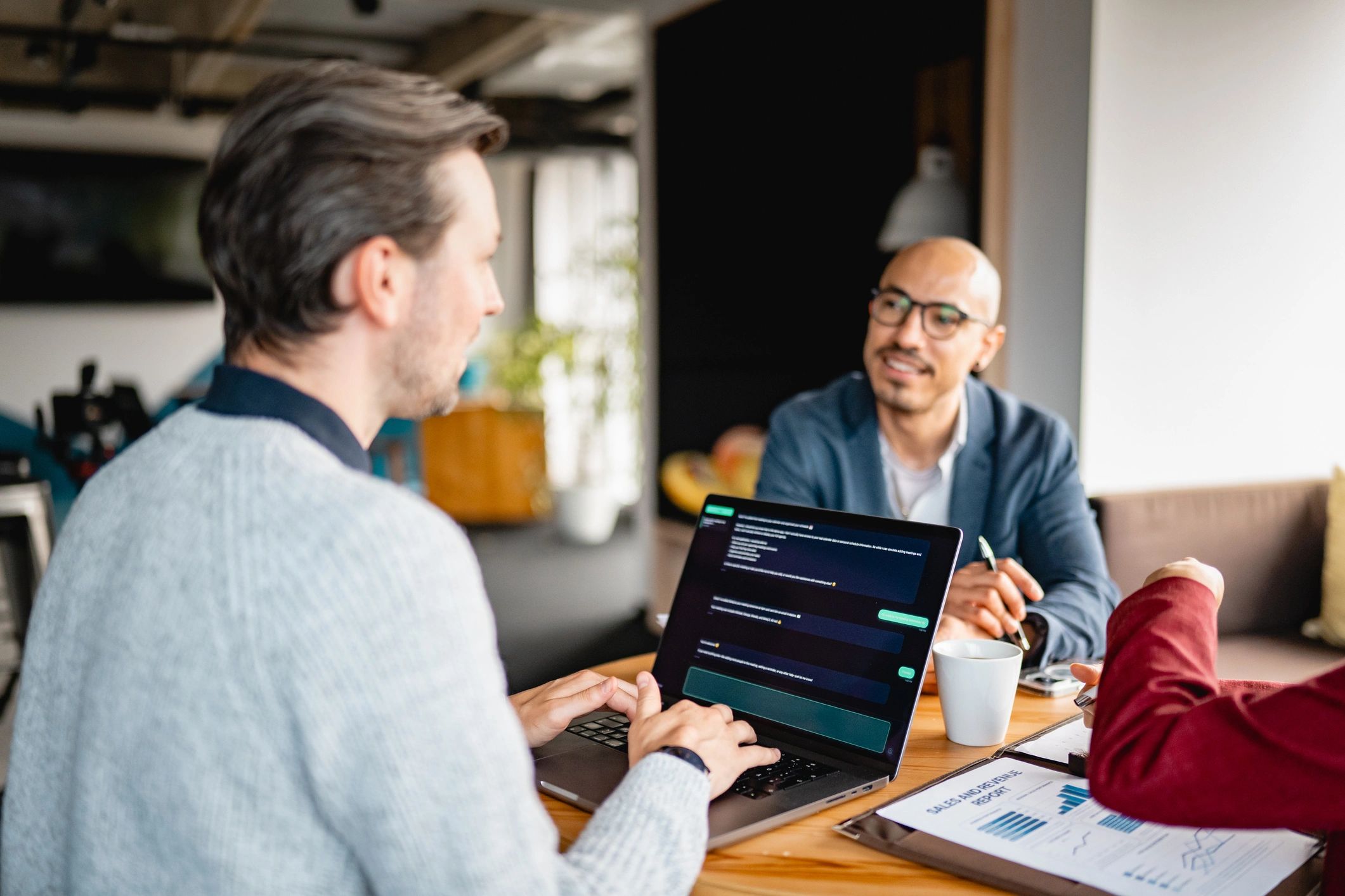 Business owners reviewing lease and purchase numbers on a laptop