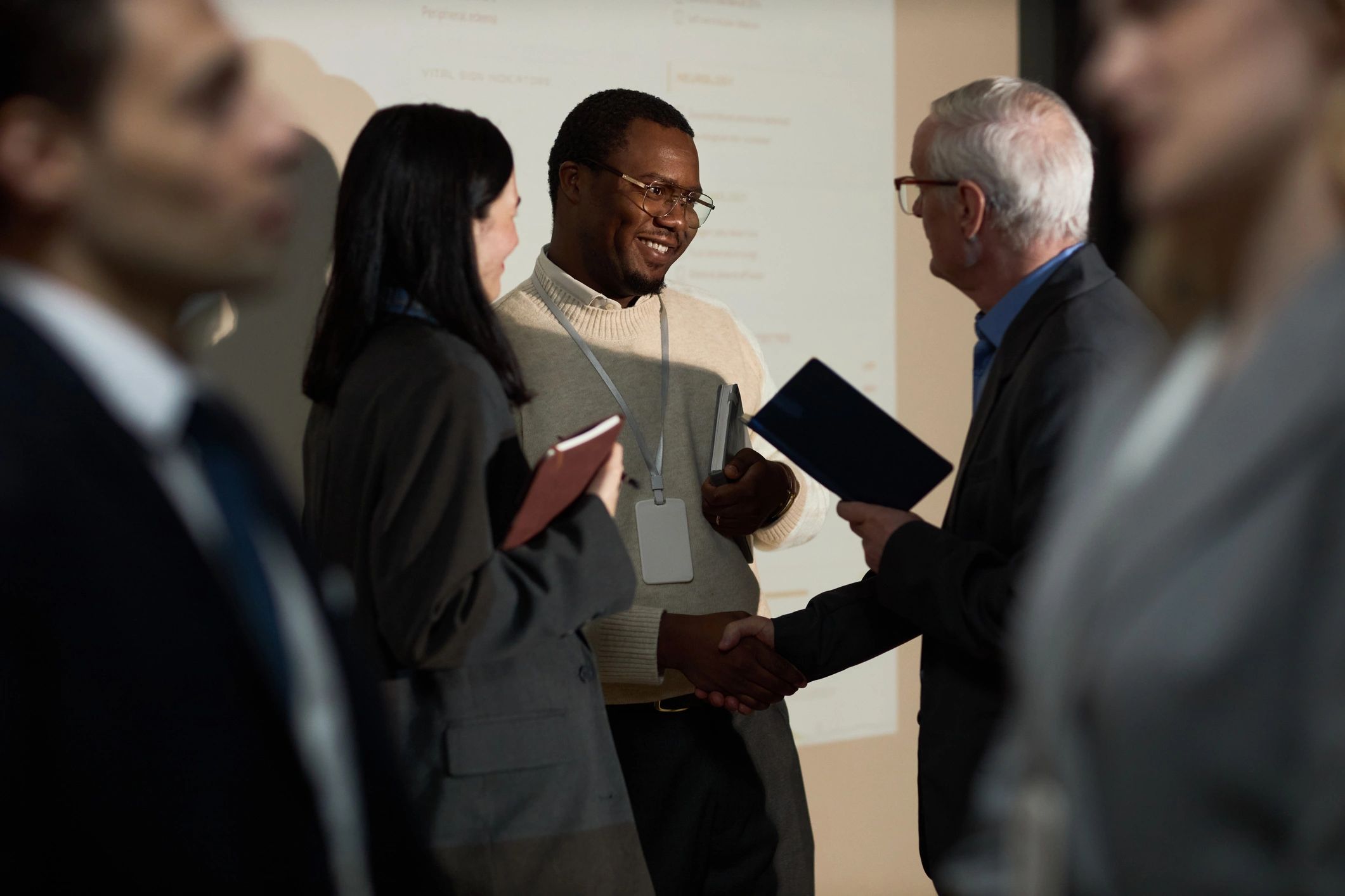 Clients and brokers shaking hands after a commercial lease meeting