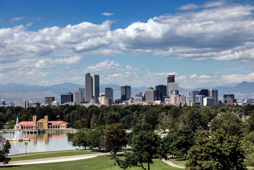 Denver skyline across the lake in City Park, the center of Colorado commercial real estate markets