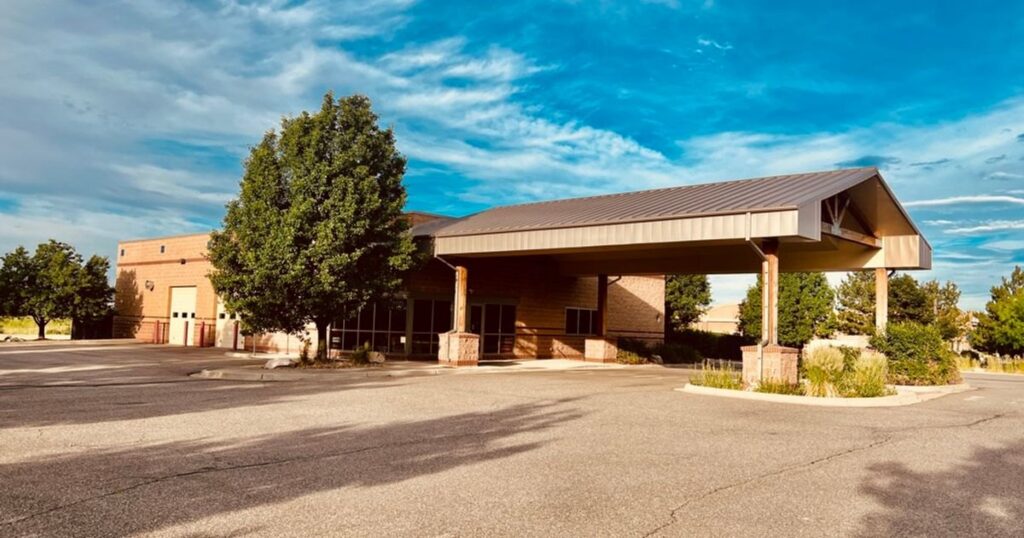 Single-story automotive and industrial building at 18700 Longs Way in Parker, underwritten with a full investment analysis