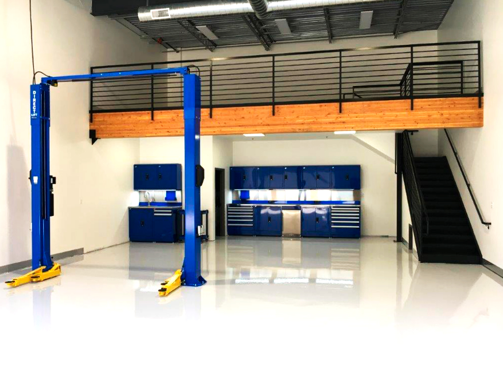 Finished garage condo unit with a two-post car lift and mezzanine