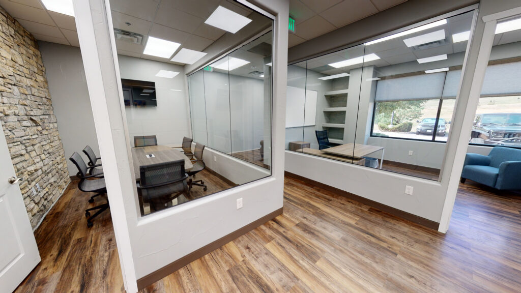 Glass-front private offices along a finished office corridor