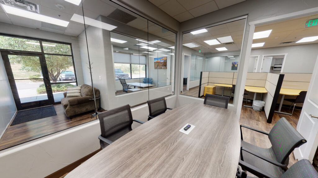 Office suite with glass-walled private offices and wood-look flooring