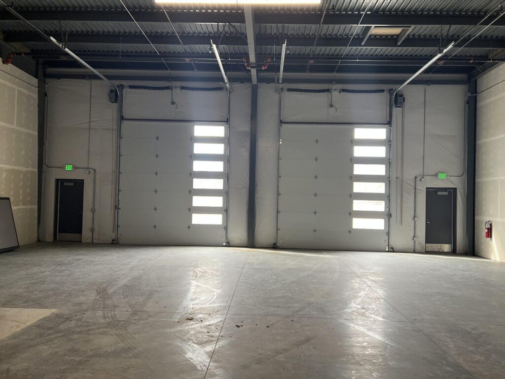 Flex condo interior with overhead doors and polished concrete floor