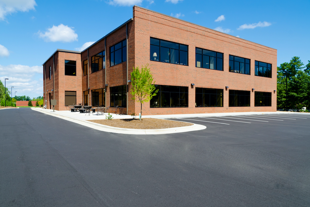 Two-story brick office building with surface parking