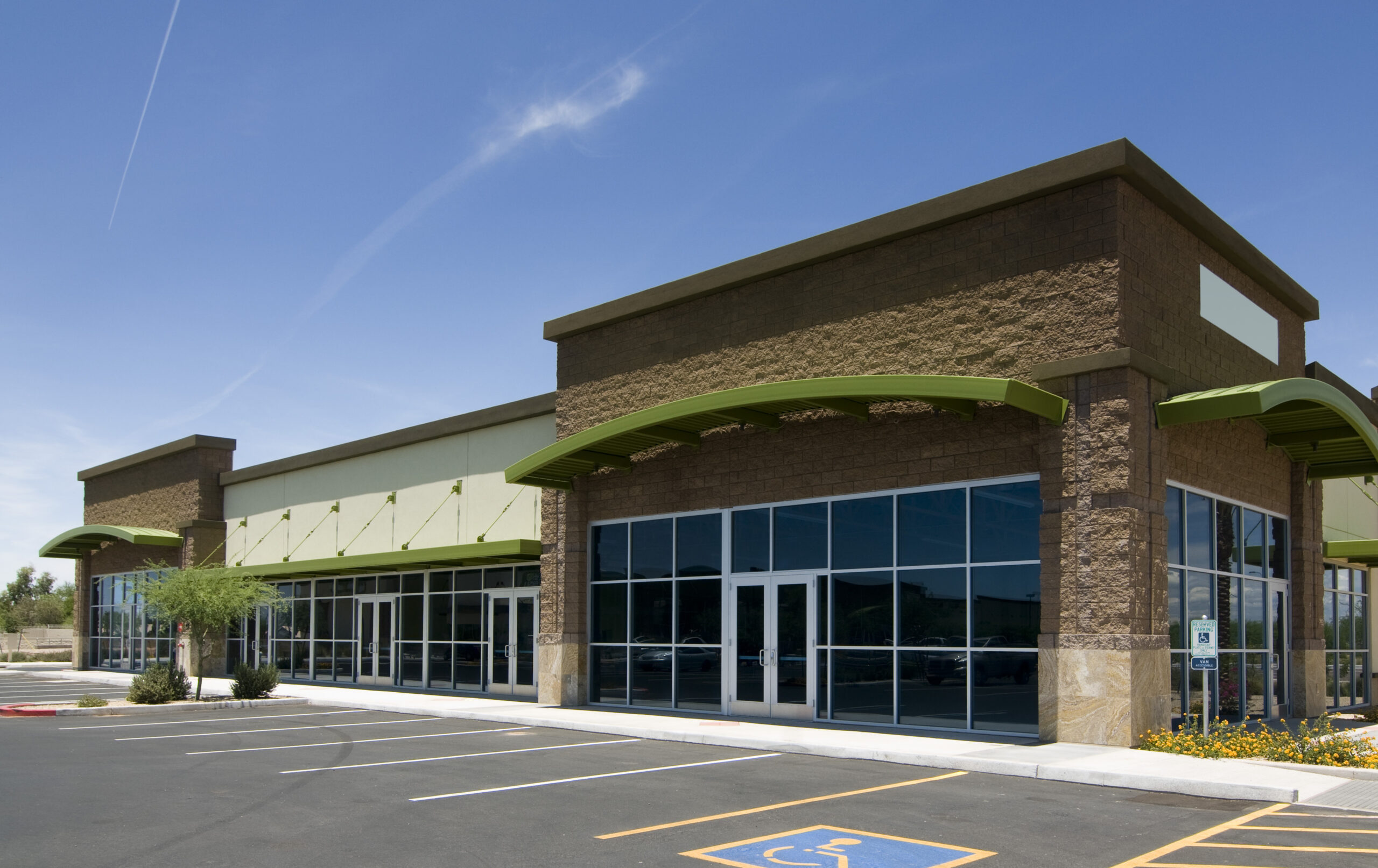 Single-story retail strip center with storefront glass